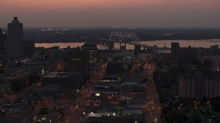 5.7K aerial stock footage orbit Hernando de Soto Bridge, seen from Downtown Memphis, Tennessee at twilight Aerial Stock Footage | DX0002_187_008