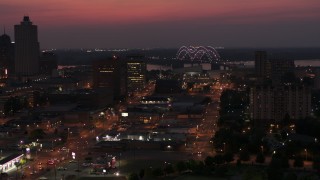 5.7K aerial stock footage a view of lights on the Hernando de Soto Bridge at twilight, Downtown Memphis, Tennessee Aerial Stock Footage | DX0002_187_021