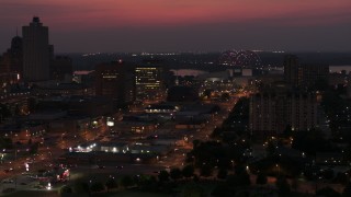 5.7K aerial stock footage of a light show on the Hernando de Soto Bridge at twilight, Downtown Memphis, Tennessee during descent Aerial Stock Footage | DX0002_187_023