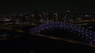 5.7K aerial stock footage of flying by the bridge with purple lights and the Downtown Memphis skyline, Tennessee Aerial Stock Footage | DX0002_187_034