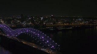 5.7K aerial stock footage ascend past the bridge with purple lights for a view of the skyline at night, Downtown Memphis, Tennessee Aerial Stock Footage | DX0002_187_037