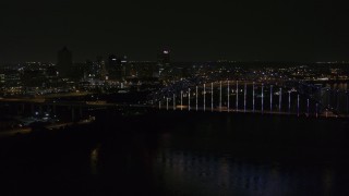 5.7K aerial stock footage of flying away from the skyline and bridge with colorful lights at night, Downtown Memphis, Tennessee Aerial Stock Footage | DX0002_187_041