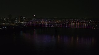 5.7K aerial stock footage a slow approach to the bridge with colorful lights and skyline at night, Downtown Memphis, Tennessee Aerial Stock Footage | DX0002_187_046