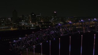 5.7K aerial stock footage of flying by the skyline at night and reveal the bridge, Downtown Memphis, Tennessee Aerial Stock Footage | DX0002_187_049