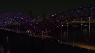 5.7K aerial stock footage of flying by colorful lights on the bridge at night near Downtown Memphis, Tennessee Aerial Stock Footage | DX0002_187_052