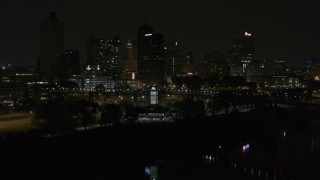 DX0002_187_055 - 5.7K aerial stock footage ascend toward skyline and welcome center at night, Downtown Memphis, Tennessee