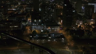 5.7K aerial stock footage reverse view of apartment high-rise and parking garage at night, Downtown Memphis, Tennessee Aerial Stock Footage | DX0002_187_066