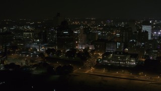 5.7K aerial stock footage orbiting downtown buildings by office high-rise at nighttime, Downtown Memphis, Tennessee Aerial Stock Footage | DX0002_187_068