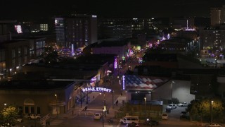 DX0002_188_020 - 5.7K aerial stock footage of flying by the Beale Street sign at nighttime, Downtown Memphis, Tennessee