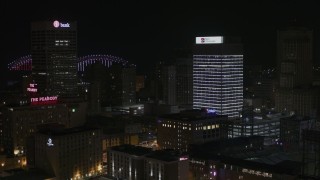 5.7K aerial stock footage of flying away from an office tower at nighttime, Downtown Memphis, Tennessee Aerial Stock Footage | DX0002_188_023