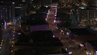 5.7K aerial stock footage of flying by numerous Beale Street clubs and restaurants at nighttime, Downtown Memphis, Tennessee Aerial Stock Footage | DX0002_188_038