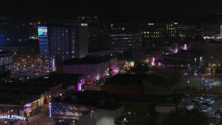 DX0002_188_041 - 5.7K aerial stock footage flyby trees to reveal the Beale Street sign and clubs and restaurants at nighttime, Downtown Memphis, Tennessee