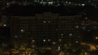 5.7K aerial stock footage of descending by an office building at nighttime, Memphis, Tennessee Aerial Stock Footage | DX0002_188_044