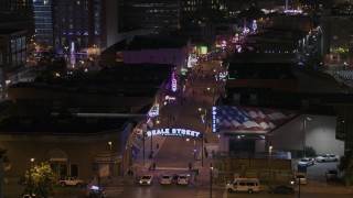 5.7K aerial stock footage ascend while focused on the Beale Street sign near clubs and restaurants at nighttime, Downtown Memphis, Tennessee Aerial Stock Footage | DX0002_188_048