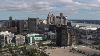 5.7K aerial stock footage flying by office buildings with a view of the skyline, Downtown Detroit, Michigan Aerial Stock Footage | DX0002_189_028