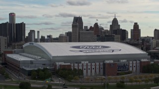 DX0002_191_029 - 5.7K aerial stock footage focus on downtown skyline while ascending past Ford Field, Downtown Detroit, Michigan