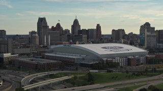 5.7K aerial stock footage of a reverse view of the football stadium and the city skyline at sunset in Downtown Detroit, Michigan Aerial Stock Footage | DX0002_191_041