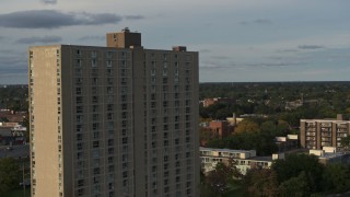 5.7K aerial stock footage fly away from and orbit the City Place Detroit apartment building at sunset, Detroit, Michigan Aerial Stock Footage | DX0002_192_002