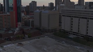 5.7K aerial stock footage descend while focusing on the Wayne County Jail Division 1 building at sunset, Downtown Detroit, Michigan Aerial Stock Footage | DX0002_192_033