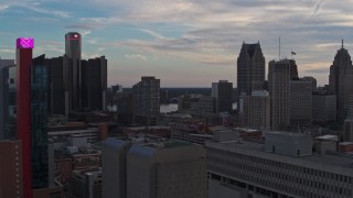 5.7K aerial stock footage flyby a hotel at sunset and focus on the city's skyscrapers, Downtown Detroit, Michigan Aerial Stock Footage | DX0002_192_037