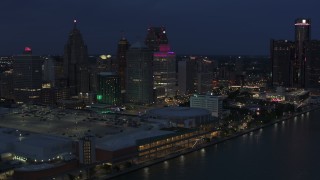 DX0002_193_005 - 5.7K aerial stock footage orbit skyscrapers at twilight, reveal GM Renaissance Center, Downtown Detroit, Michigan