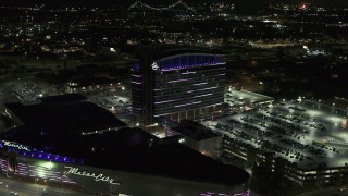 5.7K aerial stock footage reverse view of lights on the MotorCity Casino Hotel building at night, Detroit, Michigan Aerial Stock Footage | DX0002_193_020