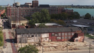 DX0002_194_021 - 5.7K aerial stock footage ascend by an abandoned factory building in Detroit, Michigan