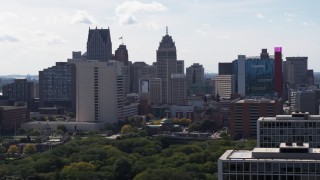 5.7K aerial stock footage flyby apartments to reveal churches between office tower and the hotel and casino, Downtown Detroit, Michigan Aerial Stock Footage | DX0002_194_043