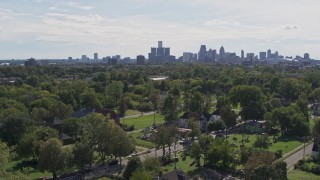 5.7K aerial stock footage of the distant skyline seen from the Heidelberg Project outdoor art display and urban homes, Detroit, Michigan Aerial Stock Footage | DX0002_195_010