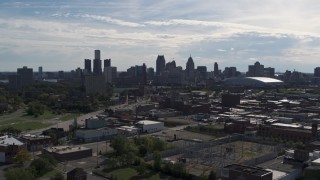 5.7K aerial stock footage ascend toward the city's skyline from brick industrial buildings, Downtown Detroit, Michigan Aerial Stock Footage | DX0002_195_019