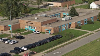 DX0002_195_031 - 5.7K aerial stock footage orbit and fly away from a police station in Detroit, Michigan