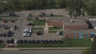 DX0002_195_034 - 5.7K aerial stock footage reverse view of the police station's front entrance in Detroit, Michigan