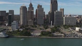 DX0002_196_013 - 5.7K aerial stock footage of circling tall skyscrapers behind Hart Plaza, Downtown Detroit, Michigan