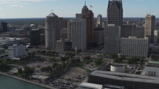 DX0002_196_014 - 5.7K aerial stock footage of orbiting tall city skyscrapers behind Hart Plaza, Downtown Detroit, Michigan