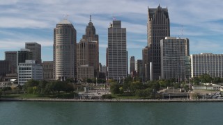 DX0002_196_018 - 5.7K aerial stock footage fly over river and Hart Plaza to approach tall city skyscrapers, Downtown Detroit, Michigan