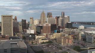 5.7K aerial stock footage of flying by an office tower to reveal skyscrapers, Downtown Detroit, Michigan Aerial Stock Footage | DX0002_196_030