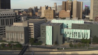 DX0002_196_042 - 5.7K aerial stock footage of orbiting and approaching the Detroit Public Safety Headquarters in Downtown Detroit, Michigan