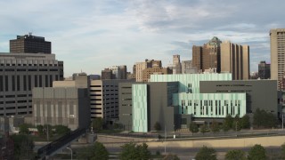 DX0002_196_046 - 5.7K aerial stock footage focus on the Detroit Public Safety Headquarters while ascending in Downtown Detroit, Michigan