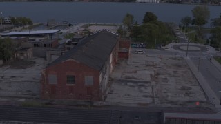 5.7K aerial stock footage orbit an abandoned Northern Cranes factory building at sunset, Detroit, Michigan Aerial Stock Footage | DX0002_197_013