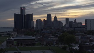 5.7K aerial stock footage focus on GM Renaissance Center and the city's skyline at sunset during ascent, Downtown Detroit, Michigan Aerial Stock Footage | DX0002_197_031