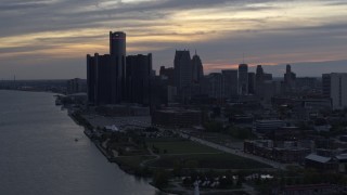 5.7K aerial stock footage of GM Renaissance Center and the city's skyline seen from river at sunset, Downtown Detroit, Michigan Aerial Stock Footage | DX0002_197_034