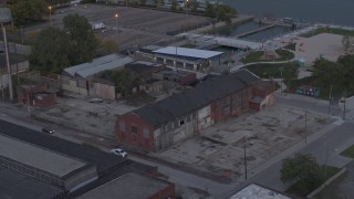 5.7K aerial stock footage flying away from an abandoned brick building at sunset, Detroit, Michigan Aerial Stock Footage | DX0002_197_052