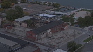 5.7K aerial stock footage of circling above an abandoned brick building at sunset, Detroit, Michigan Aerial Stock Footage | DX0002_197_053