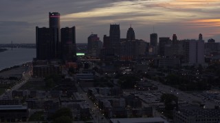 5.7K aerial stock footage of flying away from and by the city's towering skyscrapers at sunset, Downtown Detroit, Michigan Aerial Stock Footage | DX0002_198_005