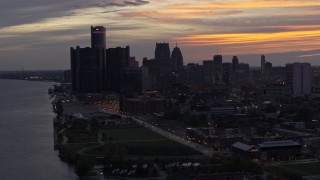 5.7K aerial stock footage the city's towering skyscrapers at sunset seen from the river, Downtown Detroit, Michigan Aerial Stock Footage | DX0002_198_006