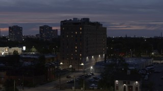 5.7K aerial stock footage orbit an apartment building at twilight, Detroit, Michigan Aerial Stock Footage | DX0002_198_022