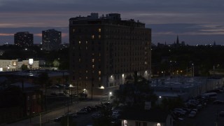 5.7K aerial stock footage descend and circle an apartment building at twilight, Detroit, Michigan Aerial Stock Footage | DX0002_198_024