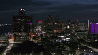 5.7K aerial stock footage of ascending toward the brightly lit city skyline at twilight in Downtown Detroit, Michigan Aerial Stock Footage | DX0002_198_032