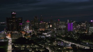 5.7K aerial stock footage of passing by the brightly lit city skyline at night, Downtown Detroit, Michigan Aerial Stock Footage | DX0002_198_034