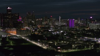 5.7K aerial stock footage of a view of the brightly lit city skyline at night, Downtown Detroit, Michigan Aerial Stock Footage | DX0002_198_036